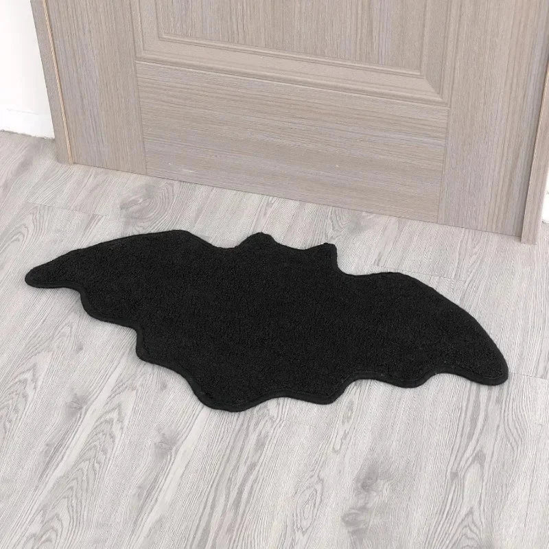 Black bat-shaped rug on a wooden floor