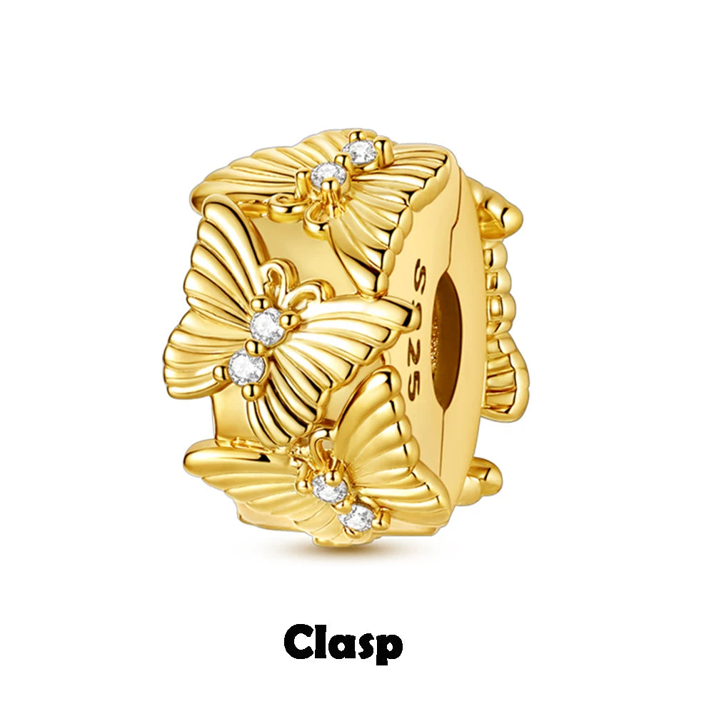 Gold clasp with floral design and diamonds on a white background