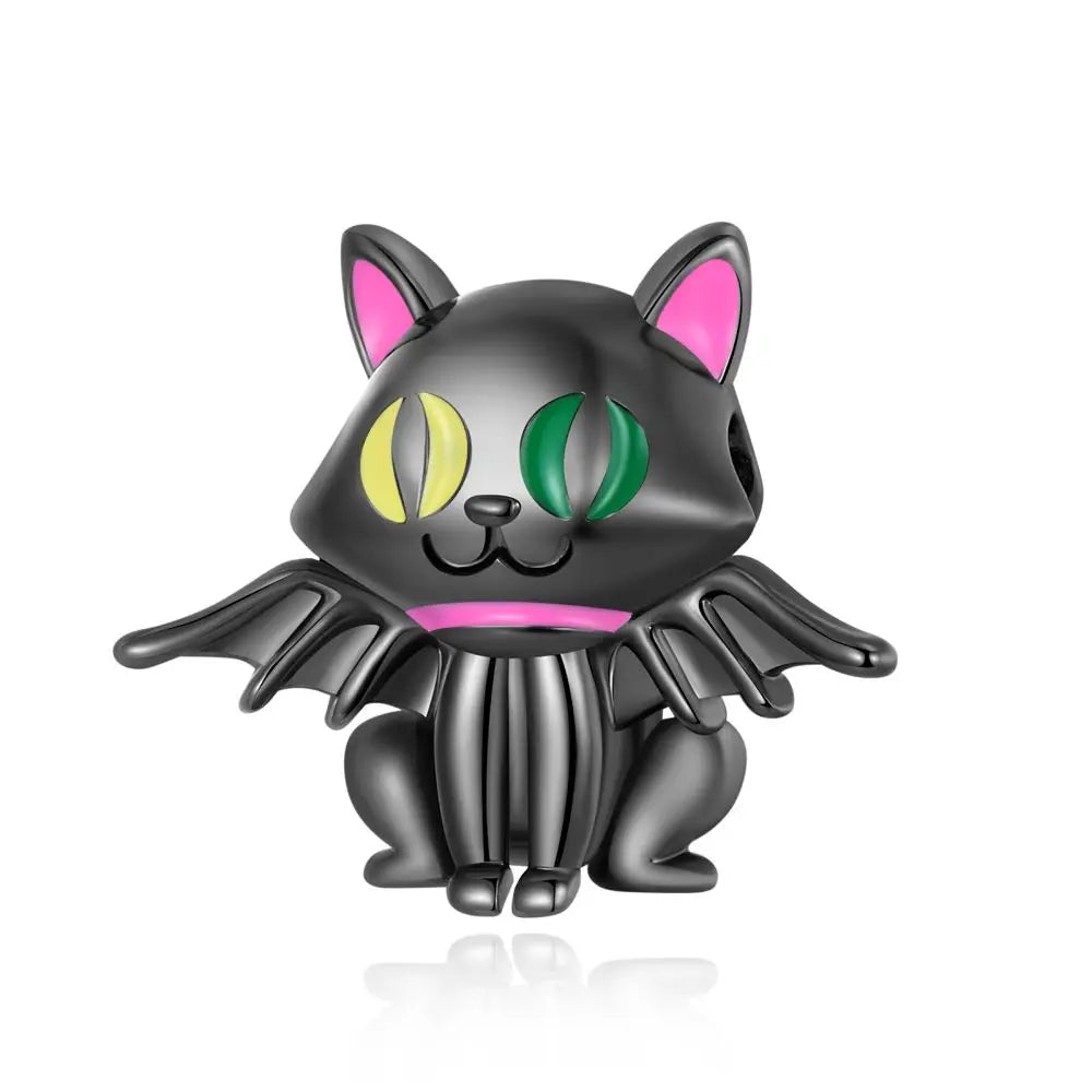 Black cat figurine with pink ears and green eyes on a white background. pandora style charm pendant. halloween, gothic.
