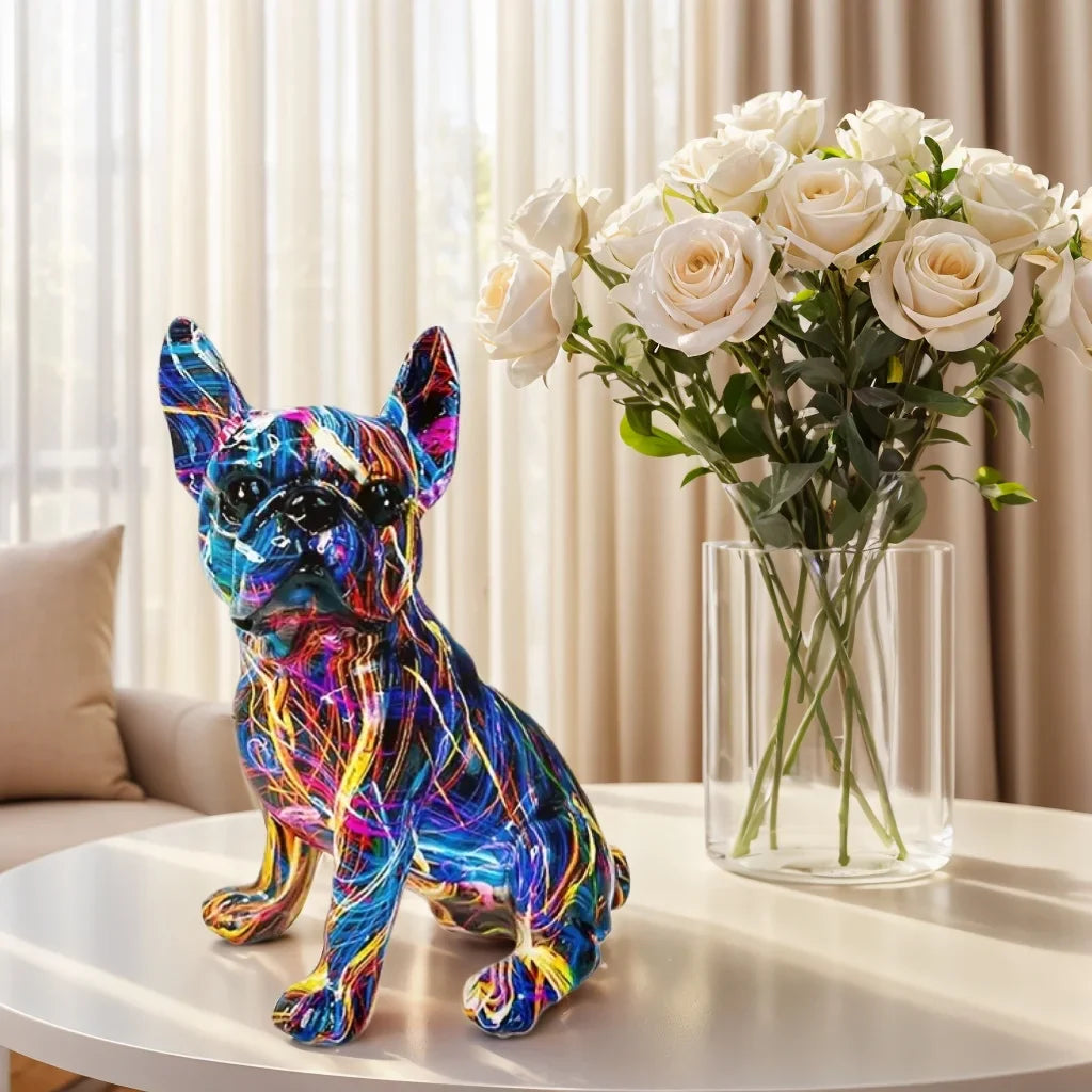 Colorful dog statue next to a vase of white roses on a table. frenchie french bulldog