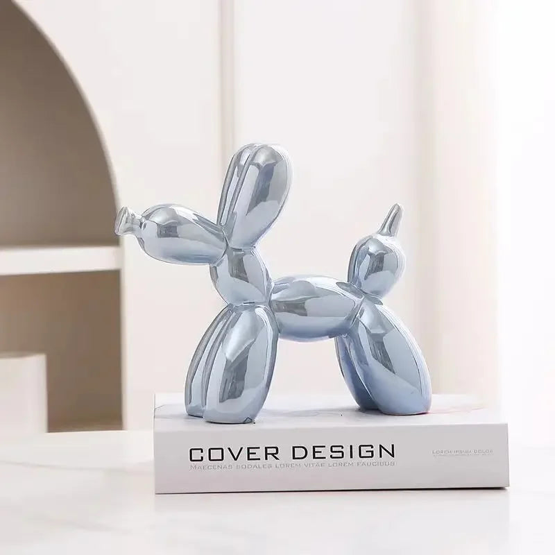 Silver balloon dog sculpture on a book with 'Cover Design' branding.