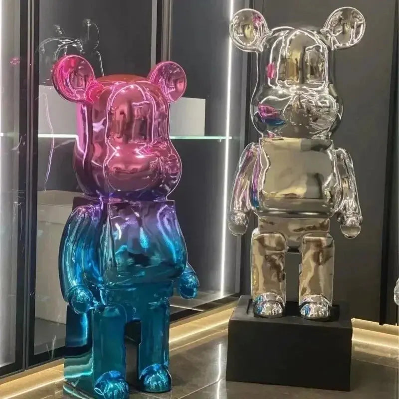 Two colorful bear-shaped figures on a reflective surface with a blurred background bearbrick collectable