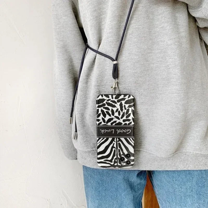 Person wearing a gray sweatshirt with a phone case on a strap over their shoulder.