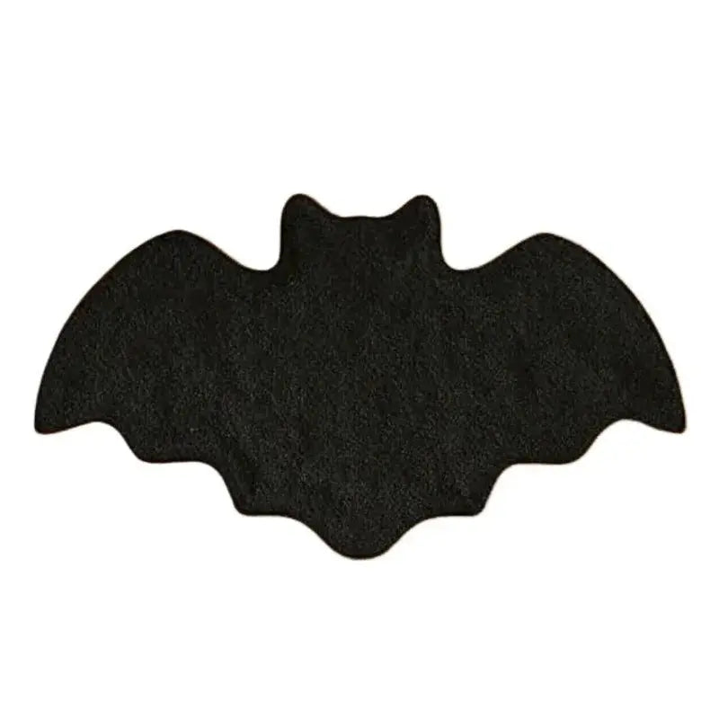 Black bat-shaped object on a white background