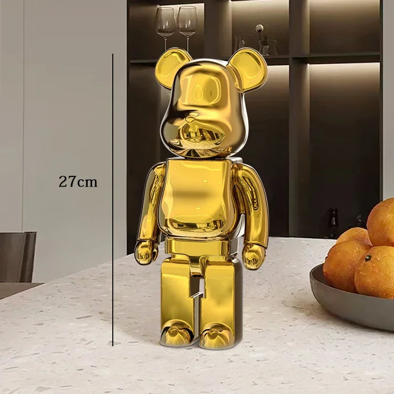 Gold bear-like figurine on a table with a kitchen background be@rbrick collectable