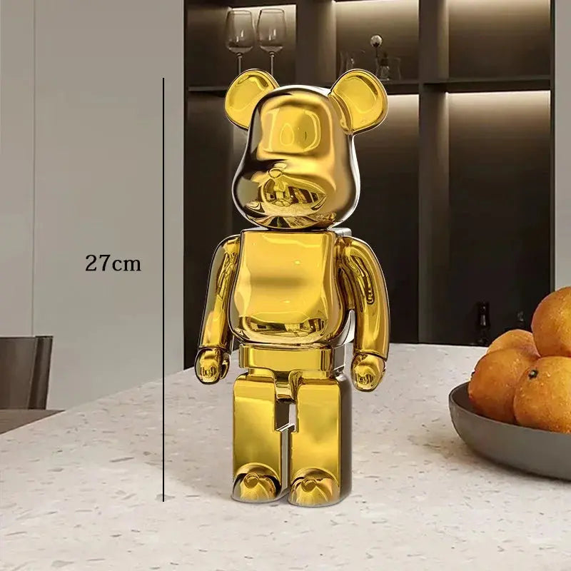 Gold bear-like figurine on a table with a kitchen background be@rbrick collectable