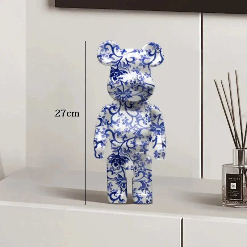 Blue and white floral patterned bear-shaped object on a white surface with measurement label be@rbrick collectable