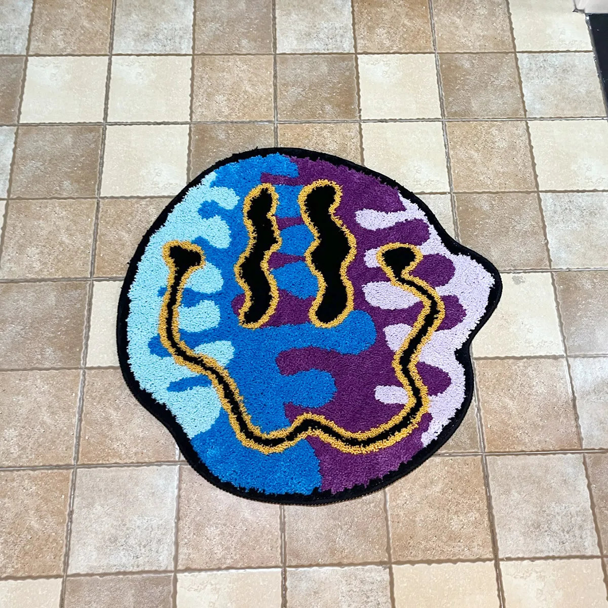 Colorful doormat with abstract design on a tiled floor