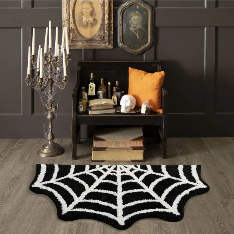 Room interior with spider web rug, candelabra, and dark wall with framed pictures.