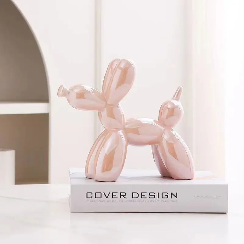 Pink balloon dog sculpture on a book with 'Cover Design' text