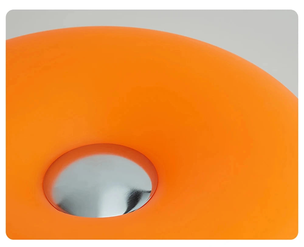 Orange object with a central circular cutout on a gray background