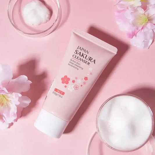 Japan Sakura cleanser tube on a pink background with flowers and foam.