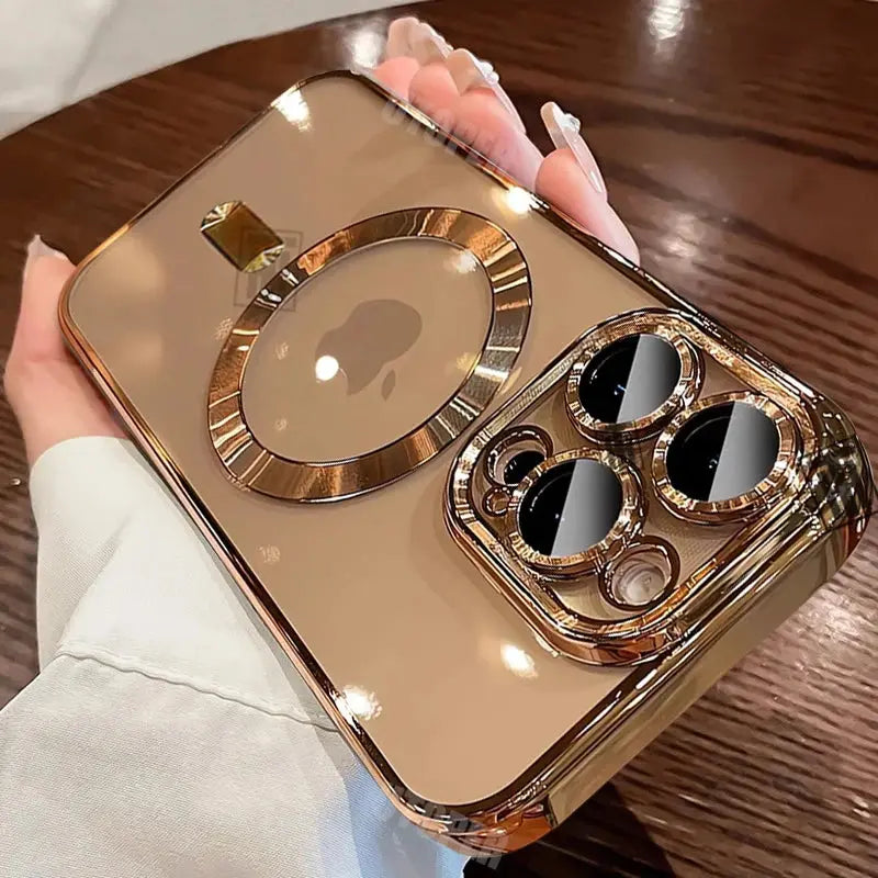 Gold phone case with reflective surface held by a hand on a wooden surface