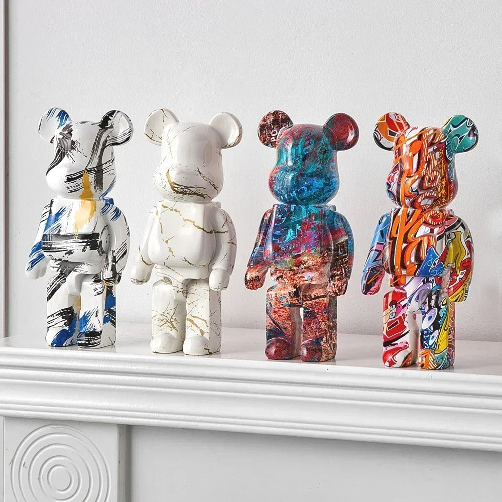 Four colorful bear figurines on a white surface with a light gray background be@rbrick collectable