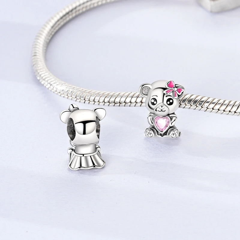 Silver bracelet with two bear charms on a light gray background. pandora style