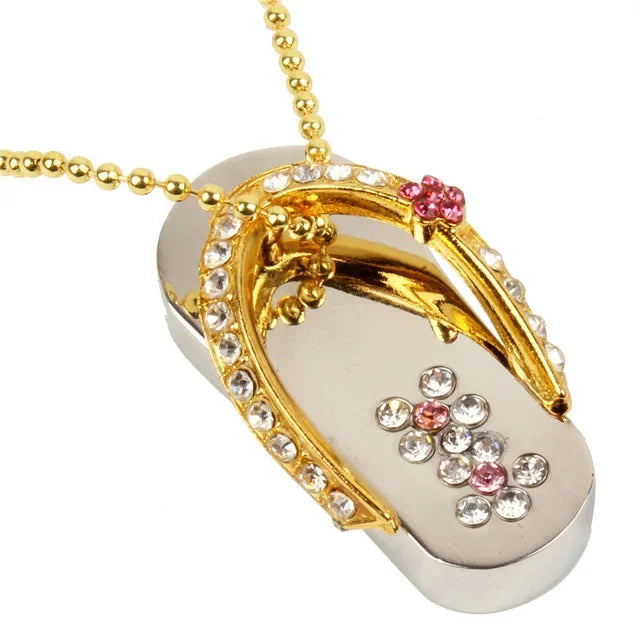 Gold and silver flip-flop-shaped pendant with gemstones on a white background