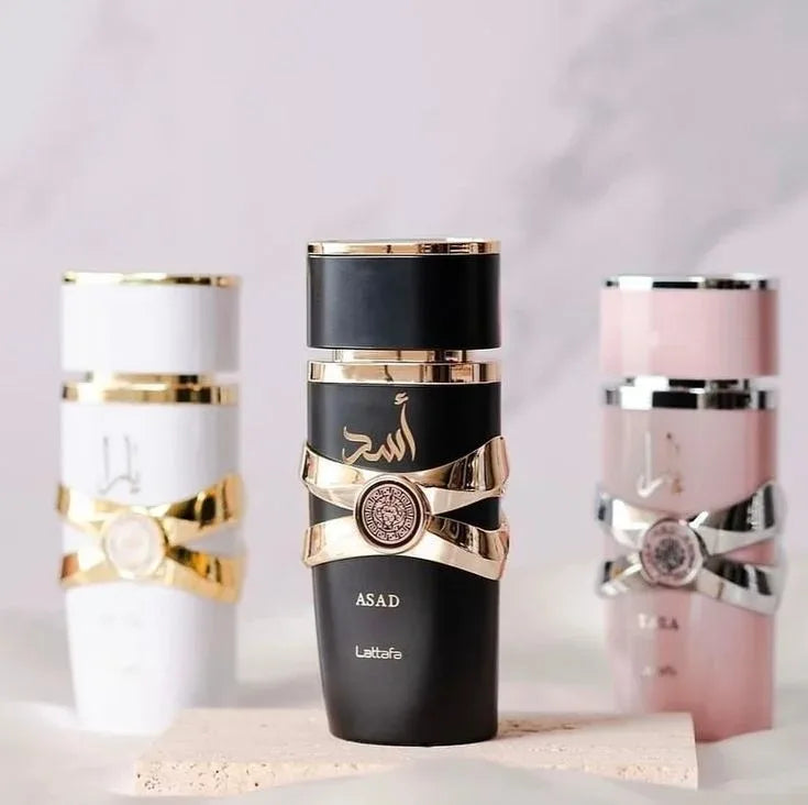 Three decorative tumblers with gold and black designs on a light background