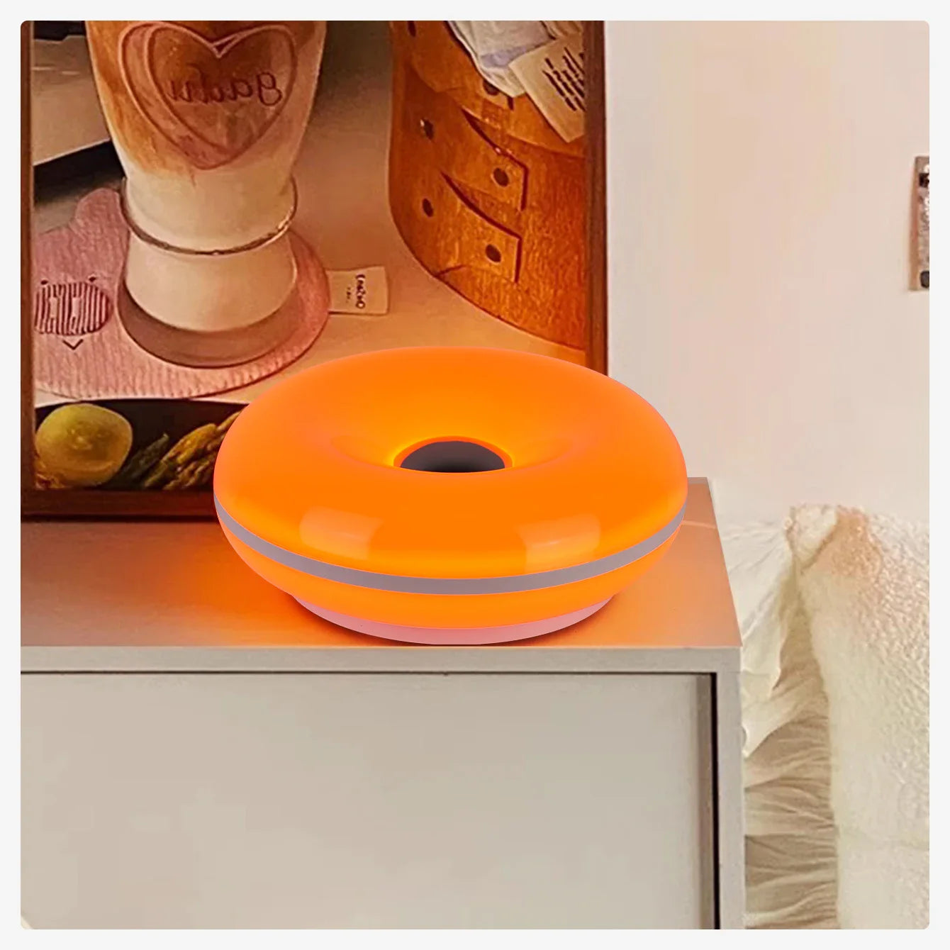 Orange donut-shaped object on a surface with a blurred background