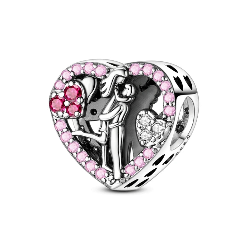 Heart-shaped charm with pink and clear gemstones on a white background