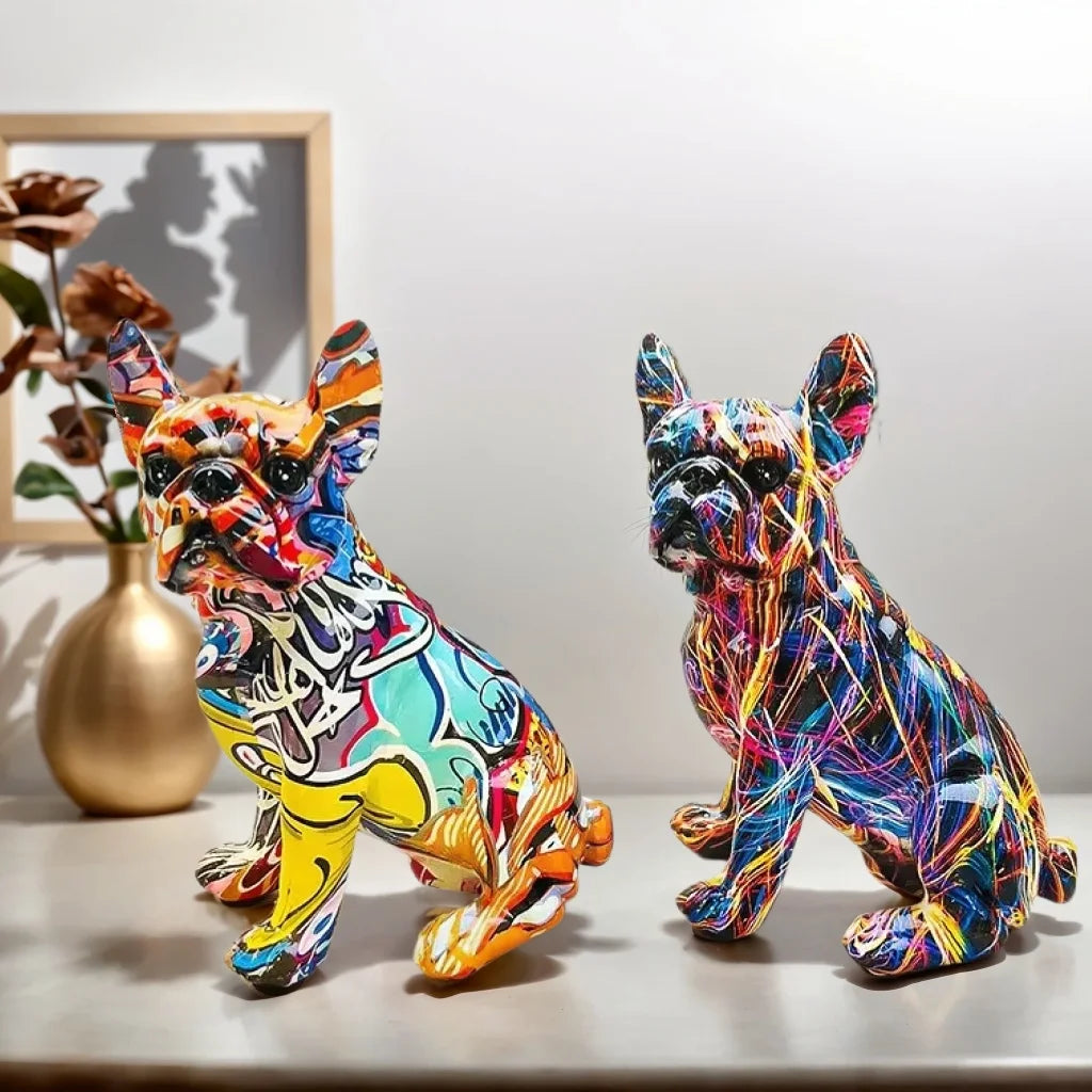 Two colorful dog figurines on a surface with a neutral background frenchie french bulldog