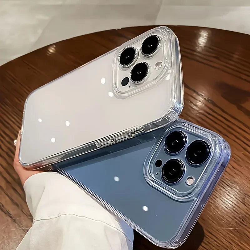 Two phone cases, one clear and one blue, on a wooden surface.
