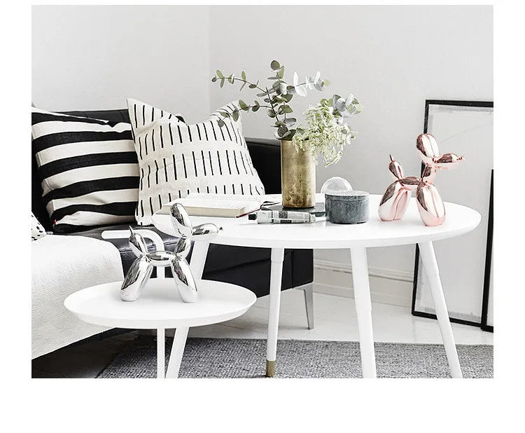 Modern living room with a sofa, coffee table, and decorative items.