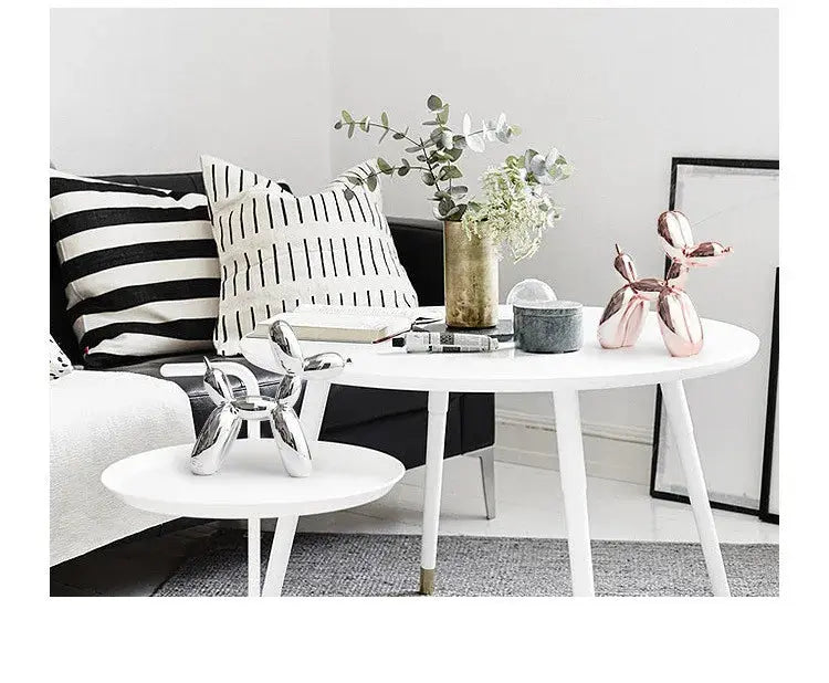 Modern living room with a sofa, coffee table, and decorative items.
