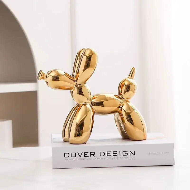 Gold dog-shaped object on a white surface with 'Cover Design' branding.