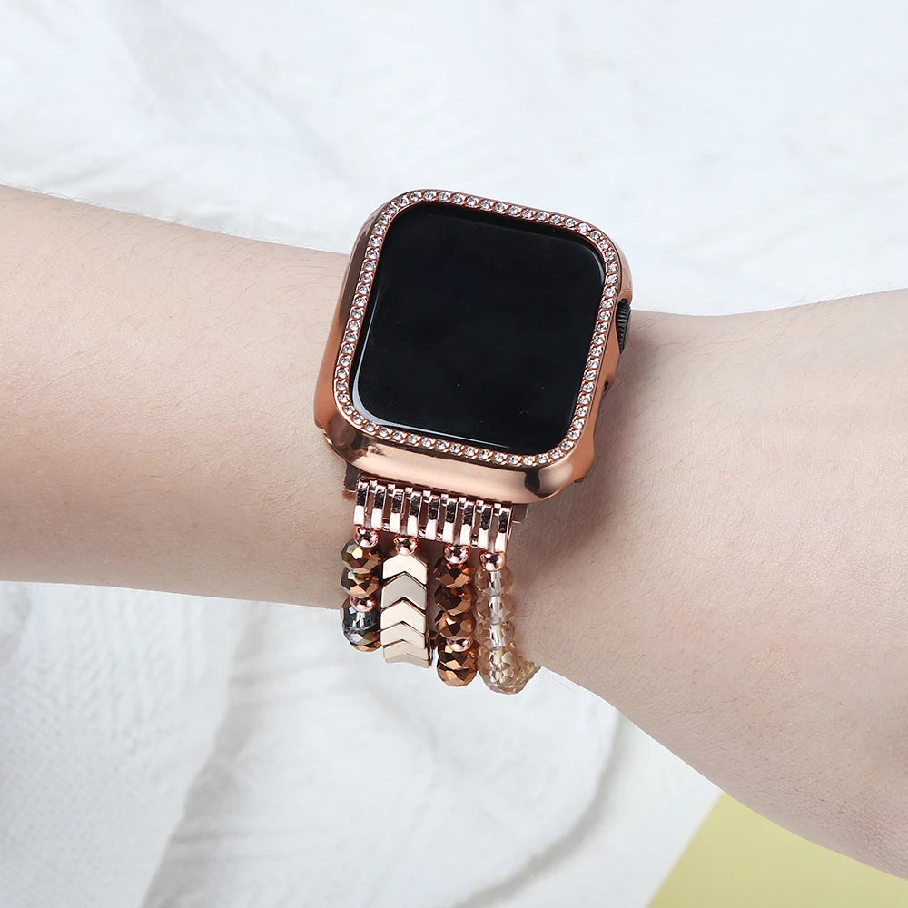 Rose gold smartwatch with decorative chain on a wrist against a white background