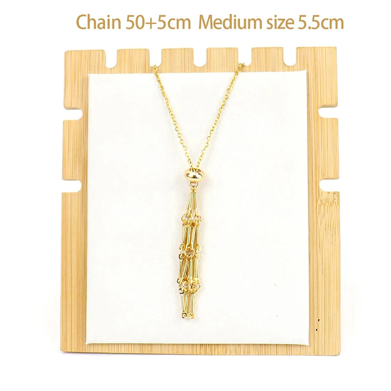 Gold necklace on a wooden display stand with measurements indicated.