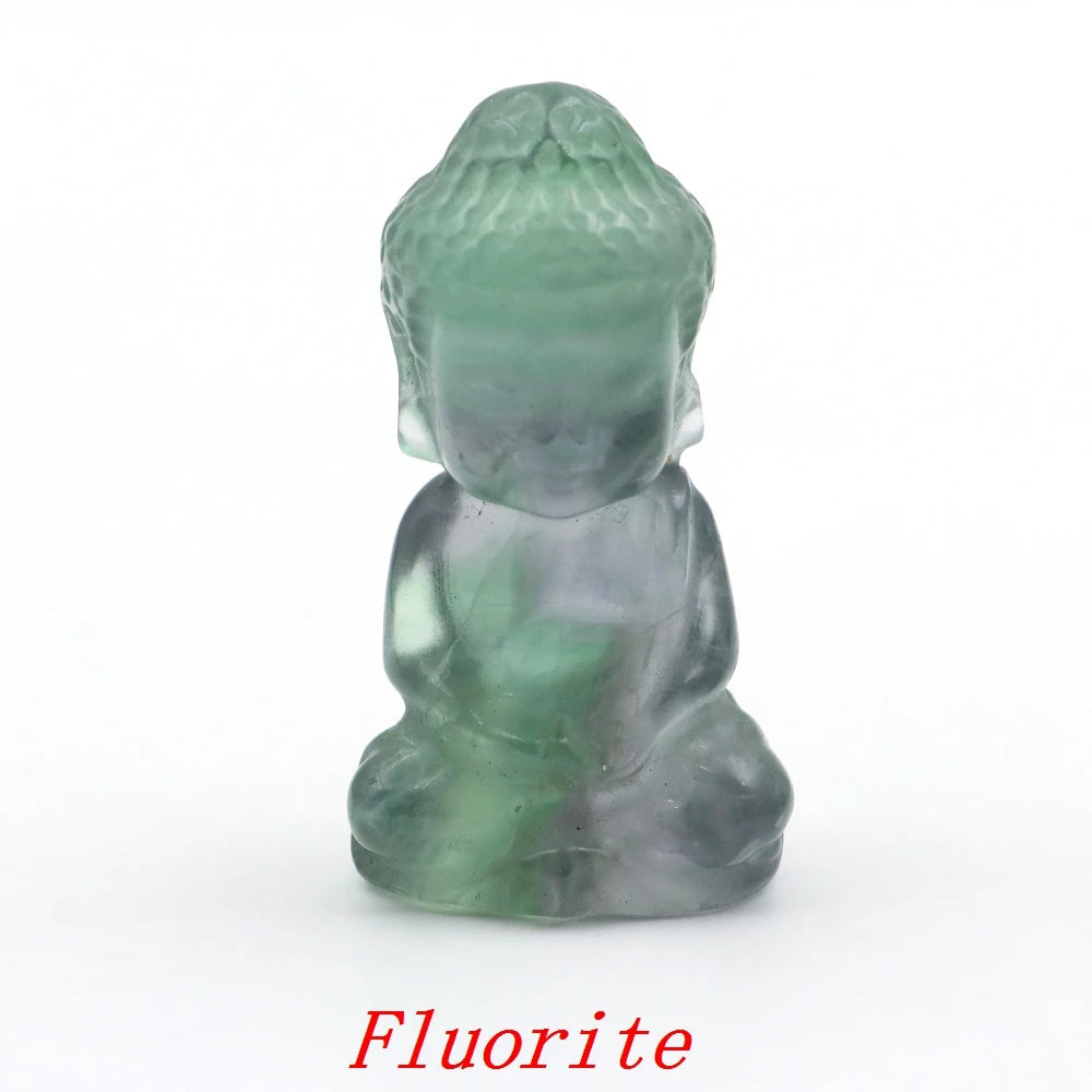 Green fluorite crystal sculpture of a seated figure on a white background