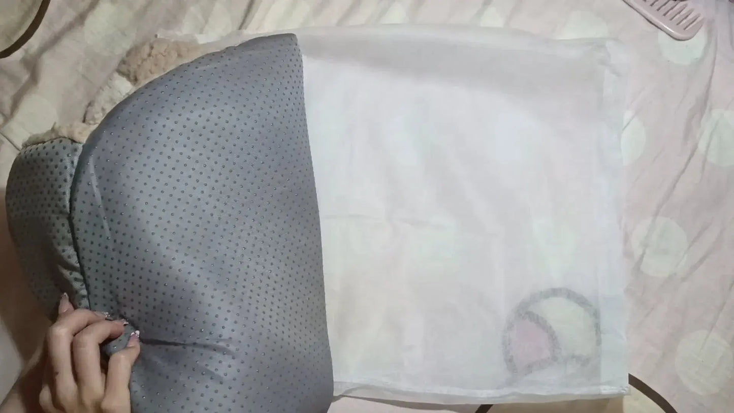 Gray pillow with a textured pattern on a light-colored surface