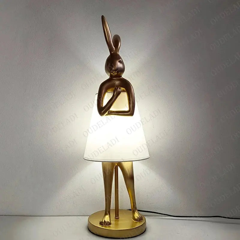 Decorative table lamp with rabbit design on a plain background