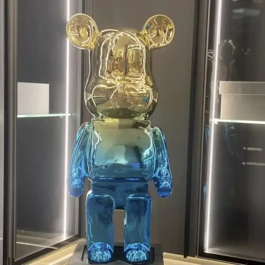 Translucent blue and gold bear-like figure in a glass case. bearbrick collectable