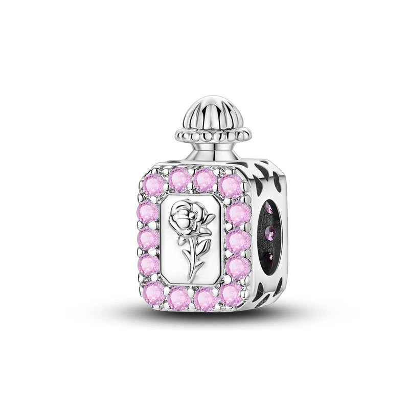 Silver charm with pink gemstones and a rose design on a white background