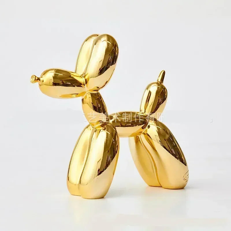 Gold balloon dog sculpture on a white background