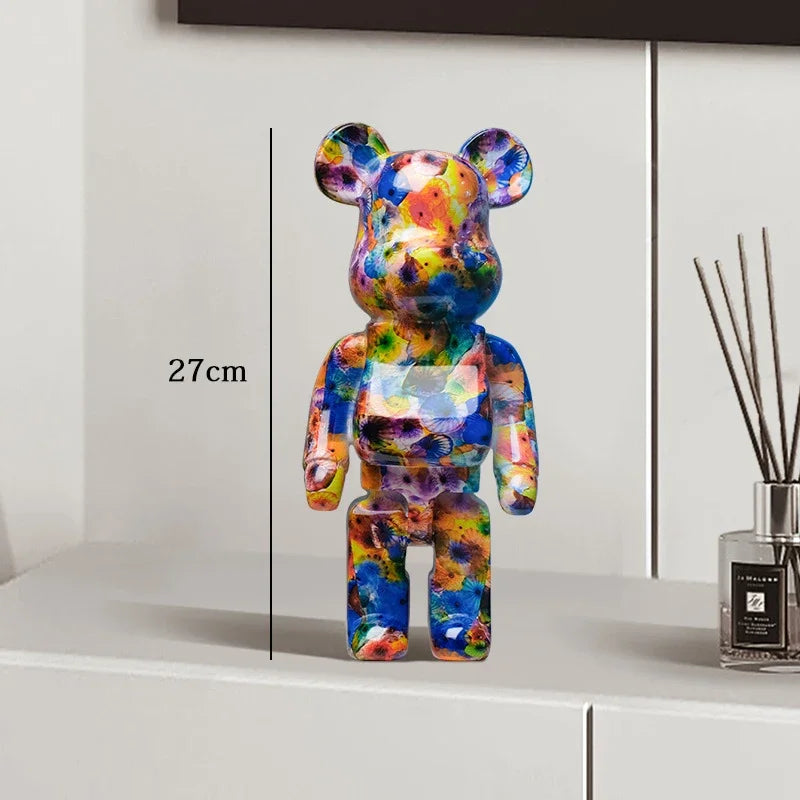 Colorful bear-shaped figure on a white surface with a measurement label, next to a diffuser. be@rbrick collectable