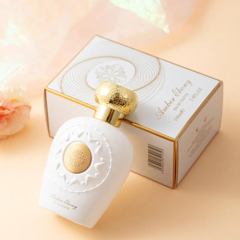Perfume bottle with gold cap and 'Cafar Elyam' branding on a light background
