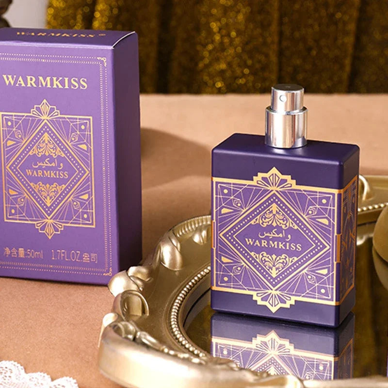 Purple perfume bottle and packaging with 'WARMKISS' branding on a reflective surface.