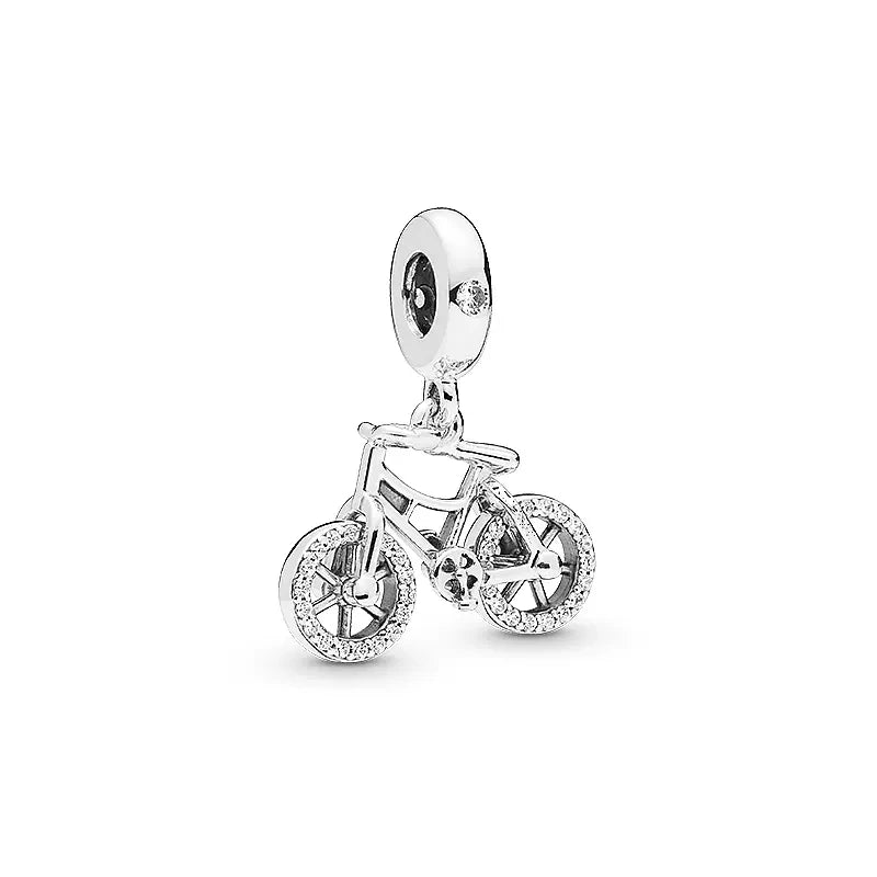 Silver bicycle charm with clear stones on a white background pandora style