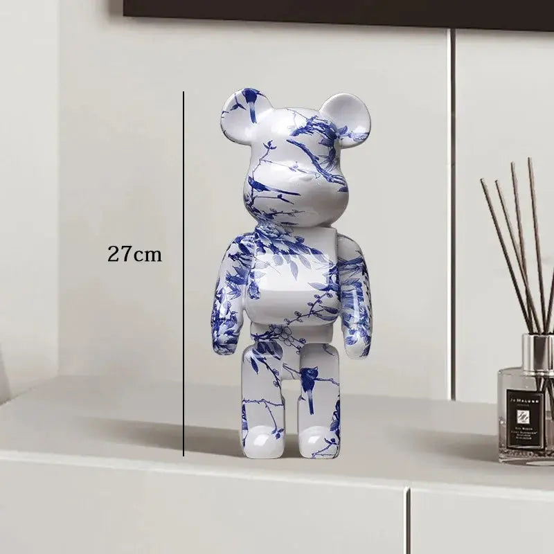 White bear figurine with blue floral patterns on a white surface, next to a diffuser. be@rbrick collectable
