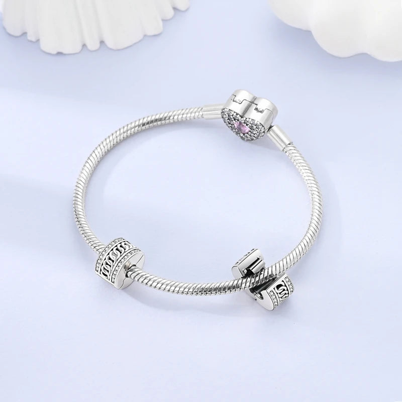 Silver bracelet with charms on a light purple background
