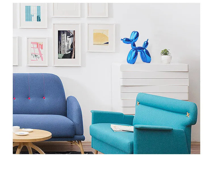 Modern living room with blue and turquoise chairs, a round table, and framed art on the wall.