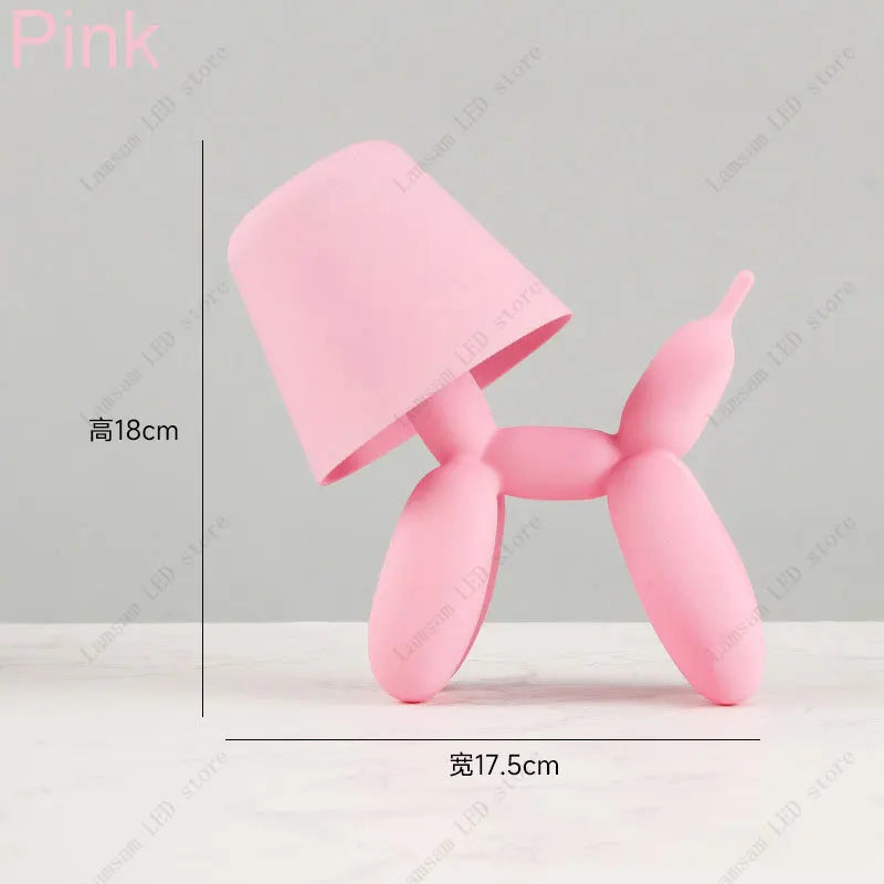 Pink balloon dog sculpture with dimensions on a gray background