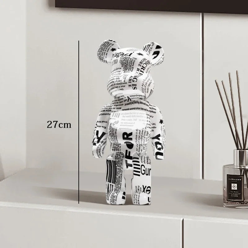Black and white bear figure with text on a shelf next to a diffuser be@rbrick collectable