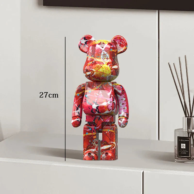Colorful bear-shaped figurine on a white surface with a measurement label, next to a diffuser. be@rbrick collectable