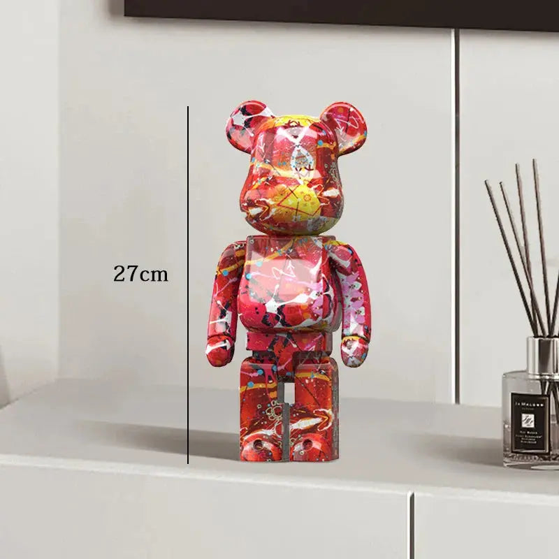 Colorful bear-shaped figurine on a white surface with a measurement label, next to a diffuser. be@rbrick collectable