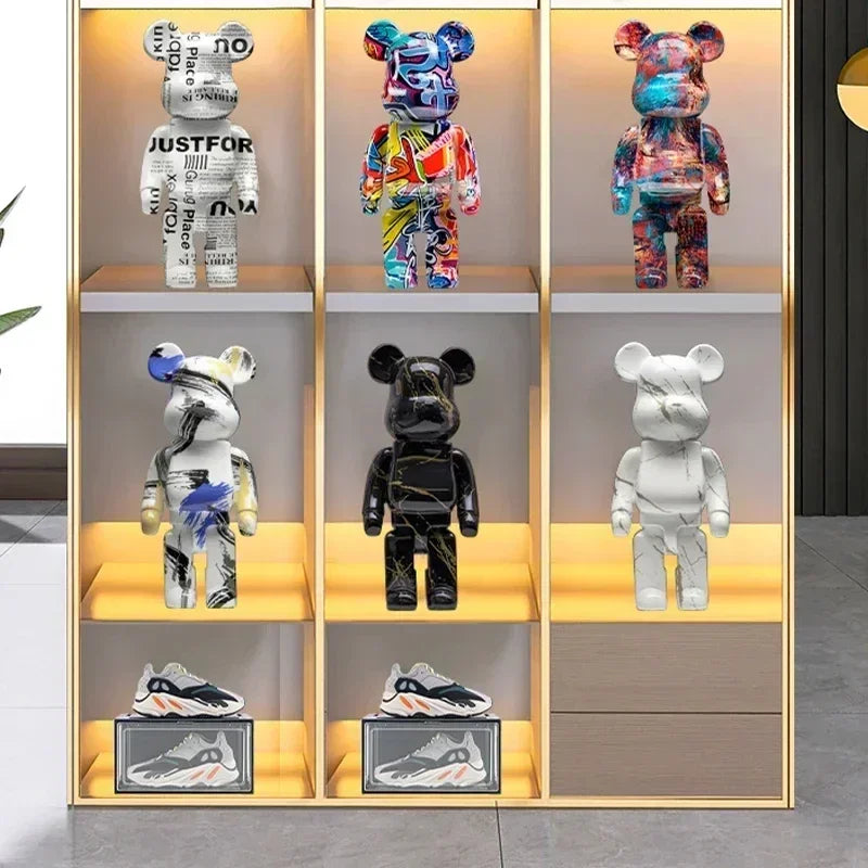 Collection of colorful and patterned bear-like figures on shelves with a neutral background. be@rbrick collectable