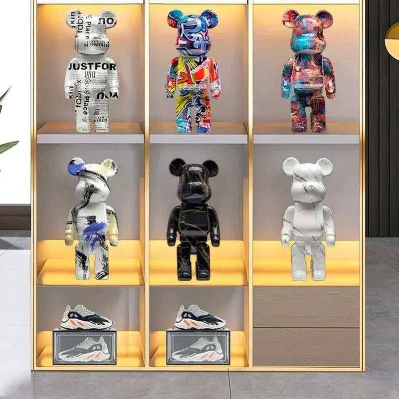 Collection of colorful and patterned bear-like figures on shelves with a neutral background. be@rbrick collectable