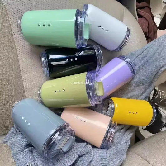 SMEG Set of colorful MEG lip glosses on a textured surface